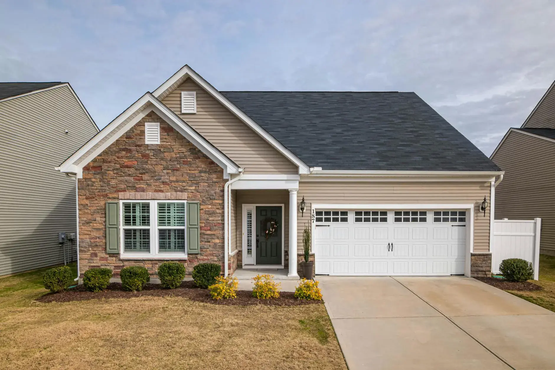 Residential garage door services in Alabama - beautiful new garage door on suburban home